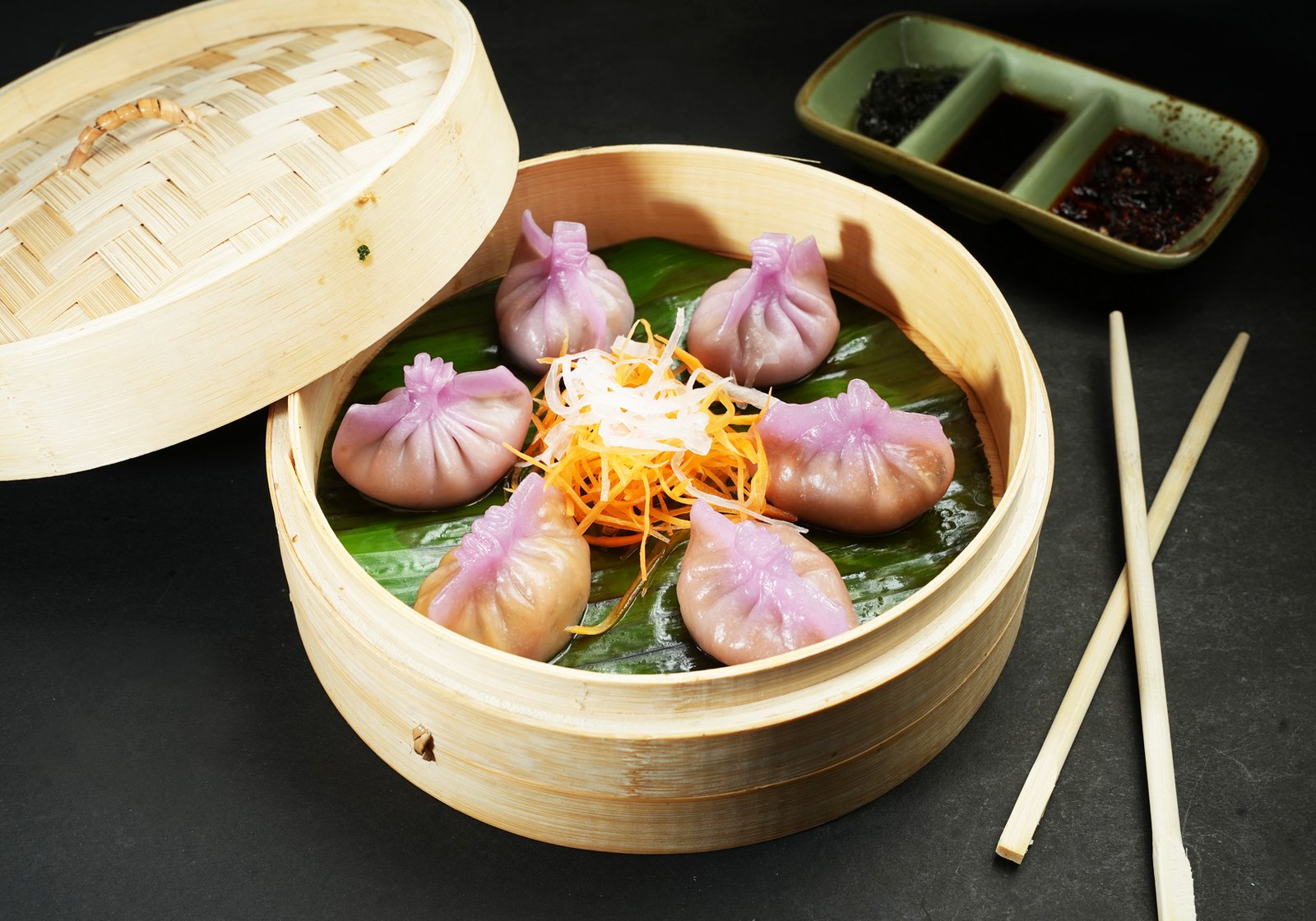 Spicy mushroom dumplings served in a bamboo basket at Kampot Haralur